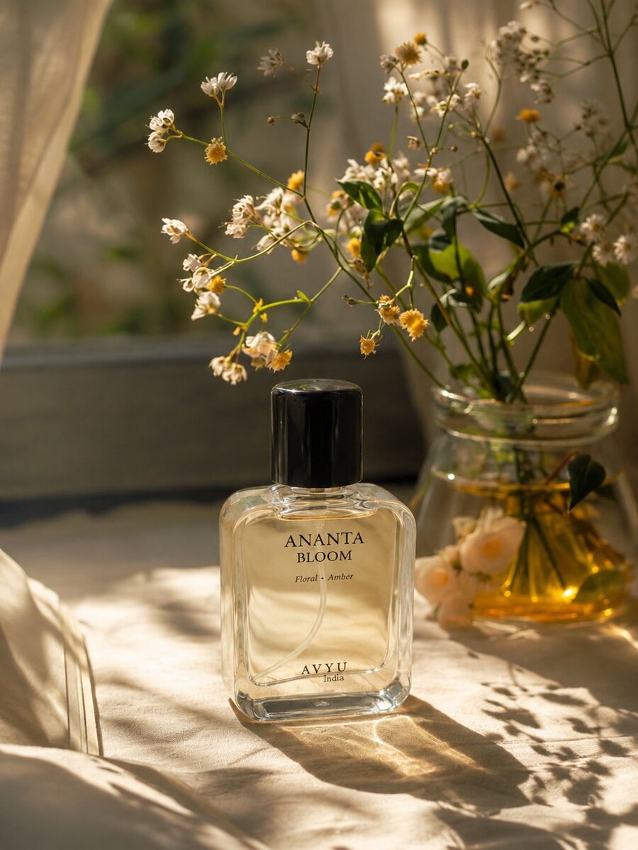 Ananta Bloom perfume beside small flowers in warm afternoon light